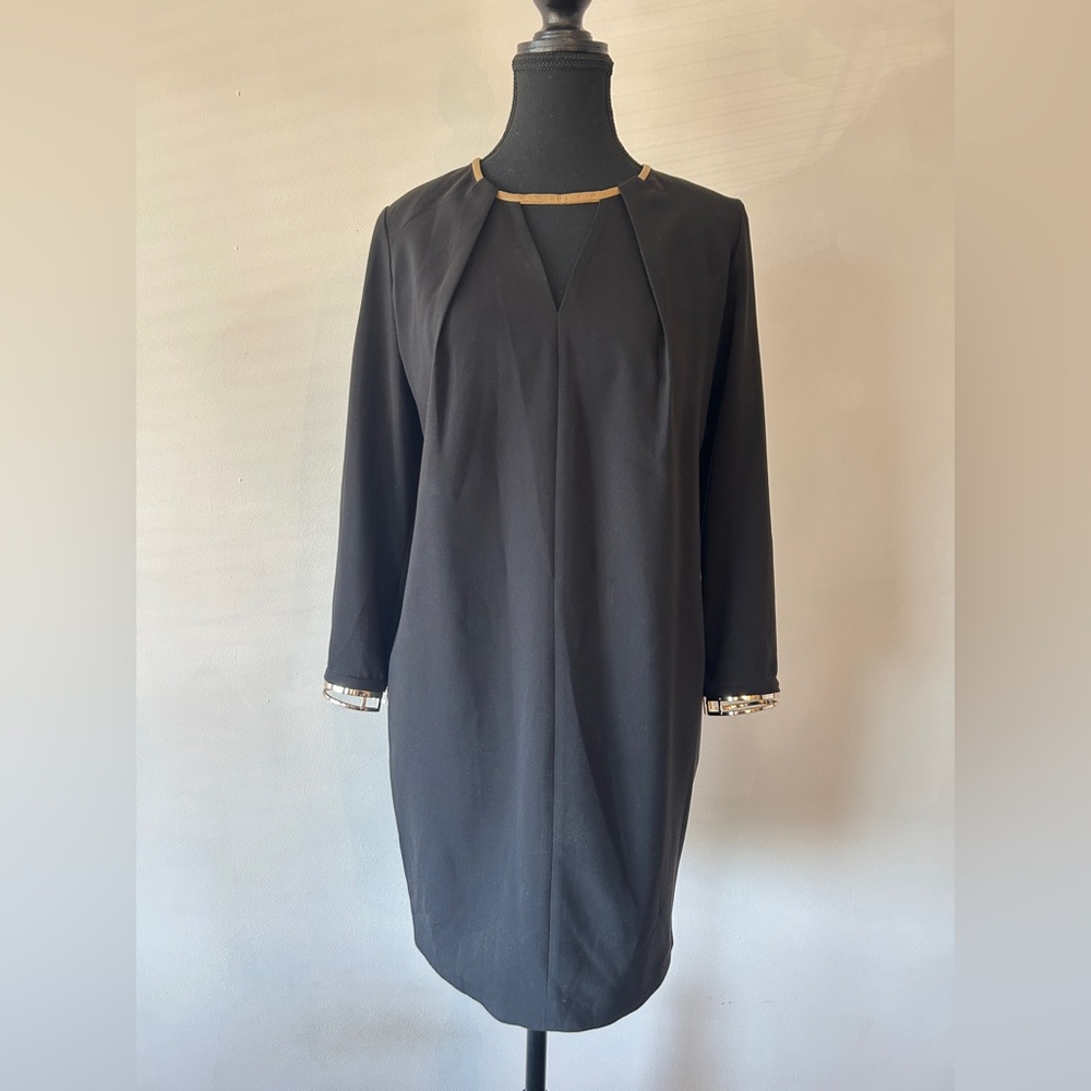 Black Tunic with gold bracelets.